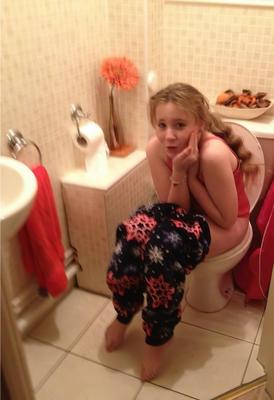 Women and Towels Hanging Up On Toilet No Shoes